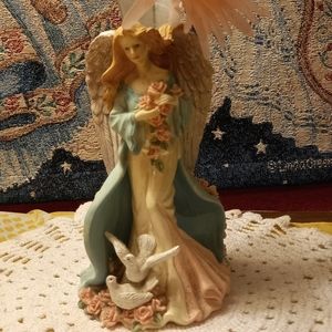 Angel with a vase on her wings.